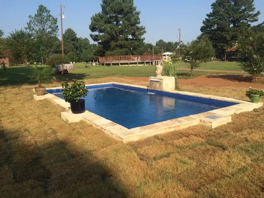 Flagstone border, two urn fountains, fresh sod