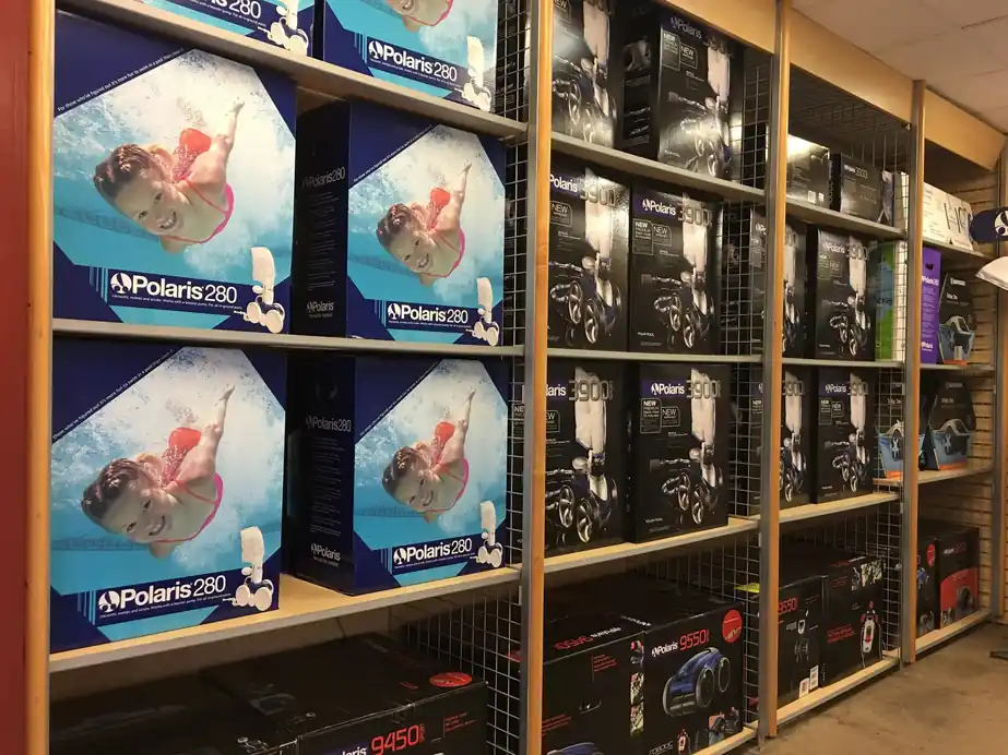 A wall of boxed Polaris robotic pool cleaners in the Loop 323 store